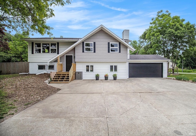 60220 Ruby St, South Bend, IN 46614 - view of front of home with a chimney, driveway, and an attached garage