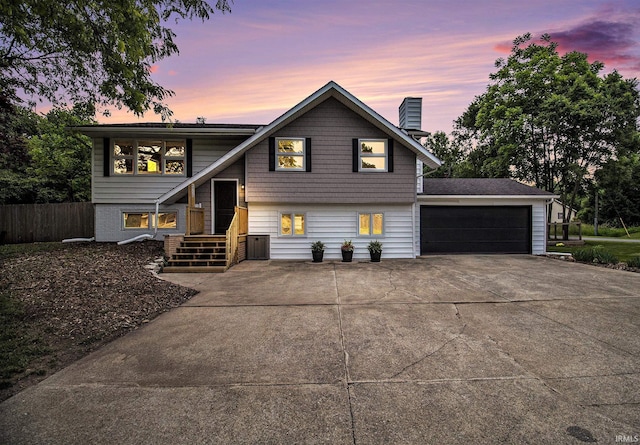60220 Ruby St, South Bend, IN 46614 - view of front facade with a chimney, an attached garage, and driveway