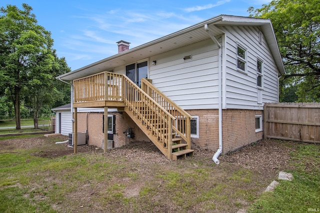 60220 Ruby St, South Bend, IN 46614 - back of property with stairway, a wooden deck, and a chimney