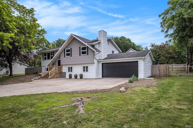 60220 Ruby St, South Bend, IN 46614 - view of front of home with concrete driveway, a chimney, a garage, and a shingled roof