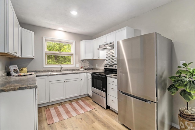60220 Ruby St, South Bend, IN 46614 - kitchen with appliances with stainless steel finishes, under cabinet range hood, light wood-style flooring, white cabinets, and recessed lighting