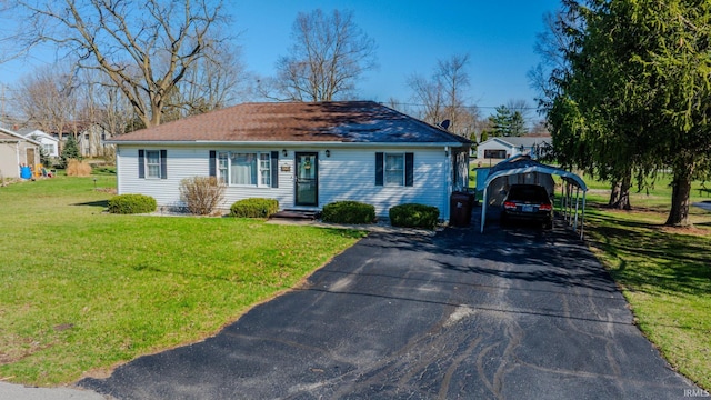 272 Sherman St, Wabash, IN 46992 - view of front facade featuring a front lawn, a detached carport, and driveway