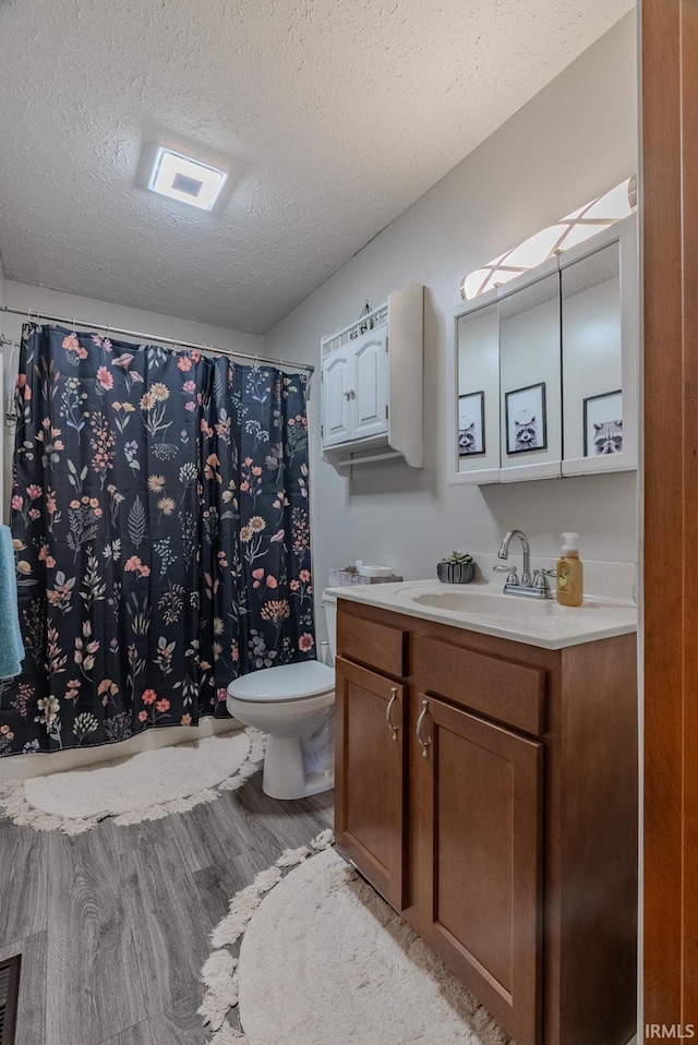 272 Sherman St, Wabash, IN 46992 - bathroom with vanity, wood finished floors, a textured ceiling, and curtained shower