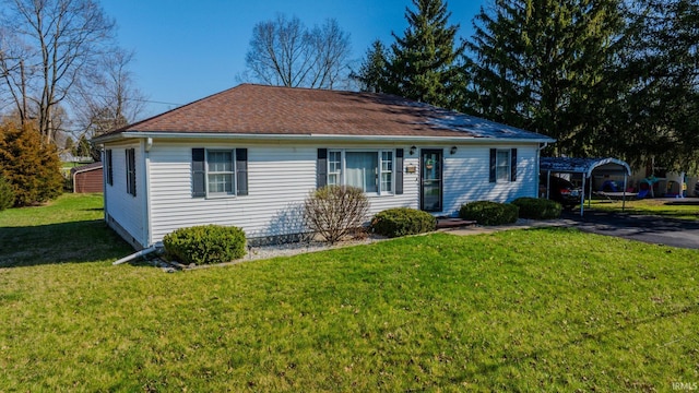 272 Sherman St, Wabash, IN 46992 - ranch-style house with a front yard, a detached carport, and a shingled roof