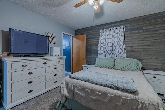 272 Sherman St, Wabash, IN 46992 - carpeted bedroom with a textured ceiling, wood walls, and a ceiling fan