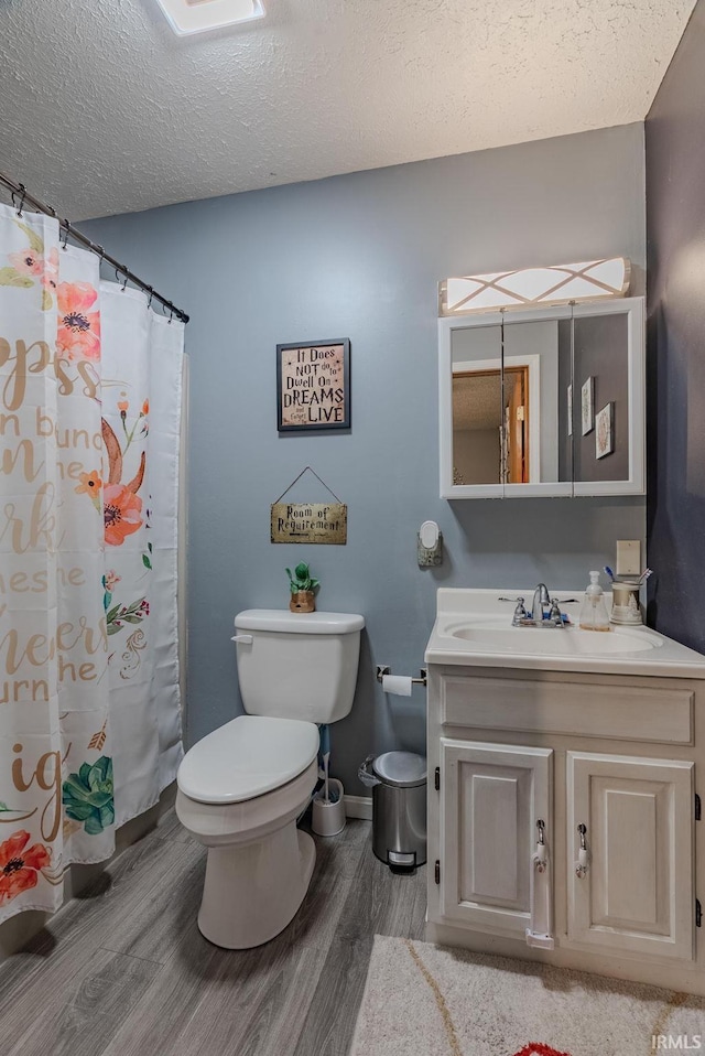 272 Sherman St, Wabash, IN 46992 - full bathroom with wood finished floors, vanity, a textured ceiling, and curtained shower