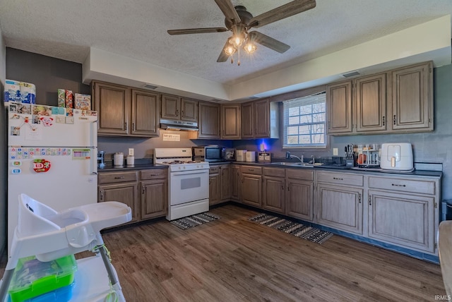 272 Sherman St, Wabash, IN 46992 - kitchen featuring white appliances, dark countertops, a textured ceiling, under cabinet range hood, and ceiling fan