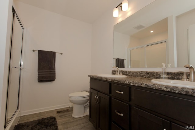 13710 Copper Strike Pass, Fort Wayne, IN 46845 - bathroom featuring a stall shower, double vanity, and wood finished floors