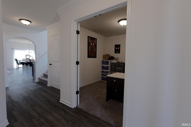 13710 Copper Strike Pass, Fort Wayne, IN 46845 - corridor featuring dark wood finished floors, arched walkways, crown molding, and stairway
