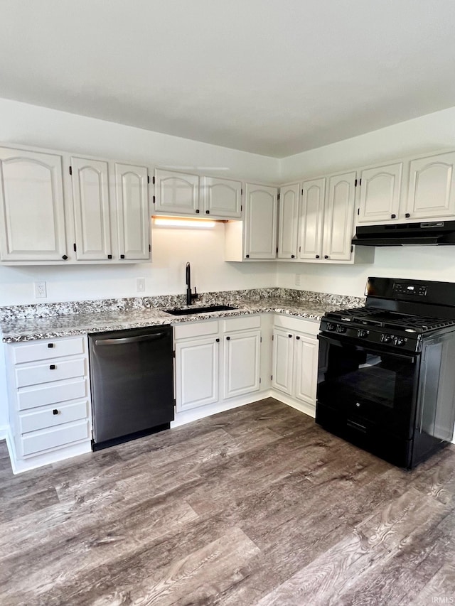 2927 Barnhart Ave, Fort Wayne, IN 46805 - kitchen featuring black gas range, dishwasher, under cabinet range hood, light stone counters, and dark wood finished floors