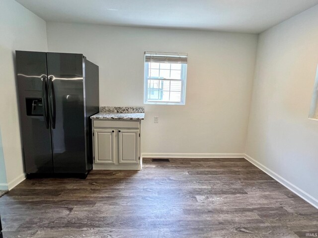 2927 Barnhart Ave, Fort Wayne, IN 46805 - kitchen with black refrigerator with ice dispenser, dark wood-style floors, and light stone countertops