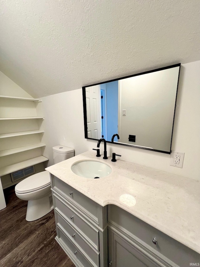 2927 Barnhart Ave, Fort Wayne, IN 46805 - bathroom with vanity, a textured ceiling, wood finished floors, and vaulted ceiling