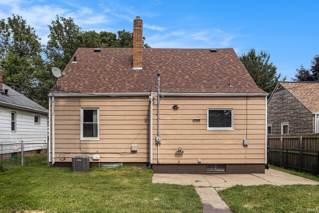 429 S Edison Ave, South Bend, IN 46619 - back of property with a fenced backyard, a chimney, and a shingled roof