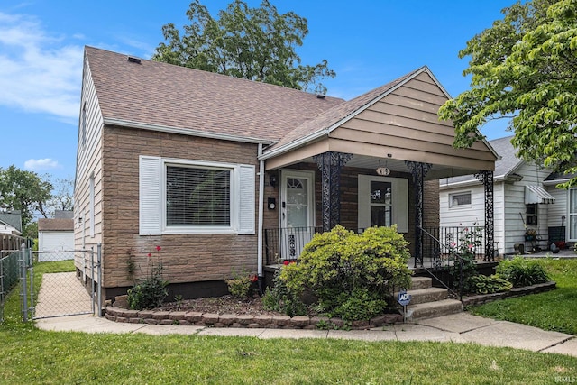 429 S Edison Ave, South Bend, IN 46619 - view of front of home featuring stone siding, roof with shingles, covered porch, and a gate