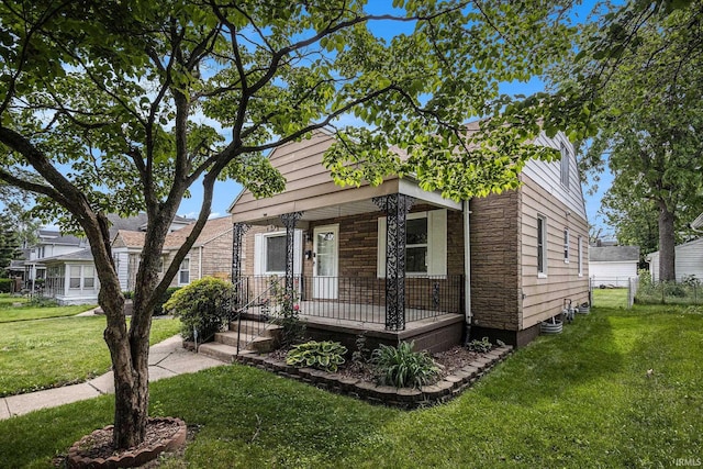 429 S Edison Ave, South Bend, IN 46619 - view of front of home featuring a porch, a front lawn, and stone siding