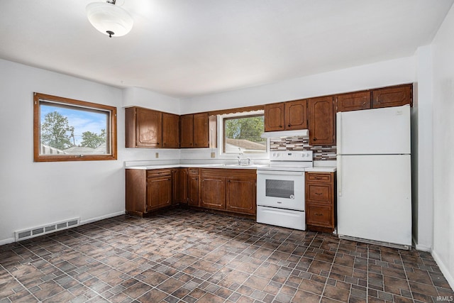 429 S Edison Ave, South Bend, IN 46619 - kitchen with white appliances, light countertops, under cabinet range hood, and stone finish floors