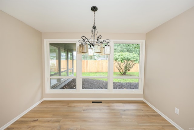 5219 Forest Grove Dr, Fort Wayne, IN 46835 - unfurnished dining area with a chandelier and light wood-style floors