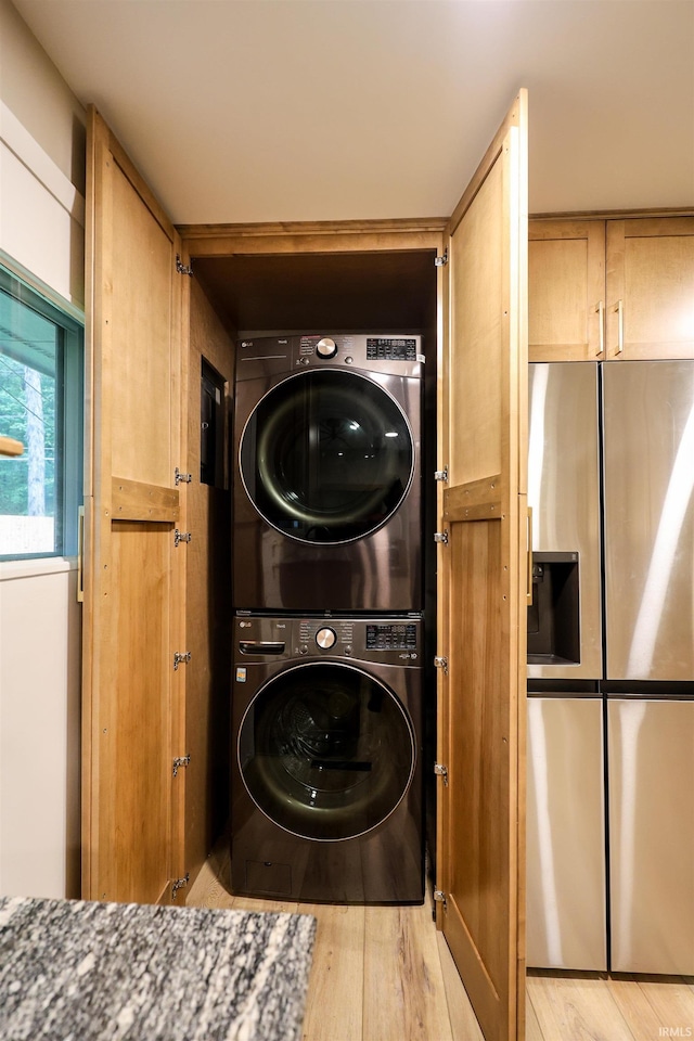 5219 Forest Grove Dr, Fort Wayne, IN 46835 - laundry area featuring estacked washer and dryer and light wood-style floors