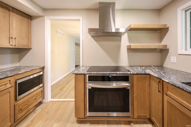5219 Forest Grove Dr, Fort Wayne, IN 46835 - kitchen with stainless steel appliances, wall chimney exhaust hood, light wood-type flooring, open shelves, and dark stone counters
