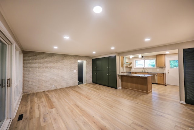 5219 Forest Grove Dr, Fort Wayne, IN 46835 - kitchen with brick wall, dishwasher, light wood-style flooring, and recessed lighting