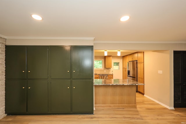 5219 Forest Grove Dr, Fort Wayne, IN 46835 - kitchen featuring stone countertops, appliances with stainless steel finishes, crown molding, light wood-style flooring, and green cabinetry