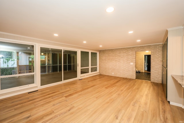5219 Forest Grove Dr, Fort Wayne, IN 46835 - spare room with brick wall, ornamental molding, light wood finished floors, and recessed lighting