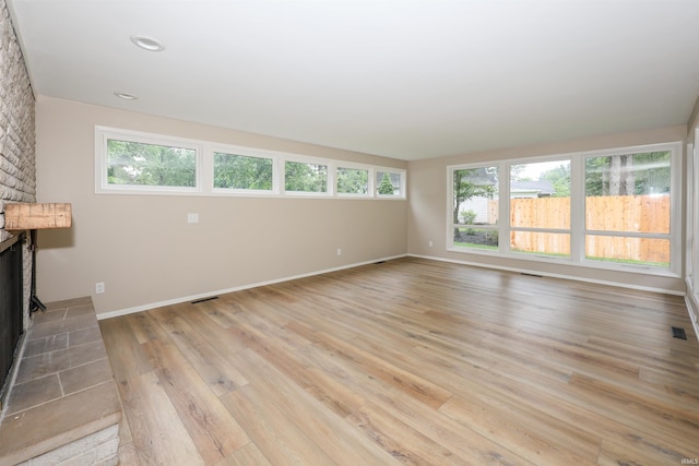 5219 Forest Grove Dr, Fort Wayne, IN 46835 - unfurnished living room featuring a fireplace, light wood finished floors, and recessed lighting