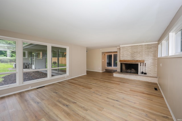 5219 Forest Grove Dr, Fort Wayne, IN 46835 - unfurnished living room with wood finished floors and a brick fireplace