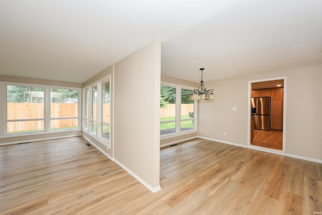 5219 Forest Grove Dr, Fort Wayne, IN 46835 - empty room featuring a chandelier and light wood-type flooring