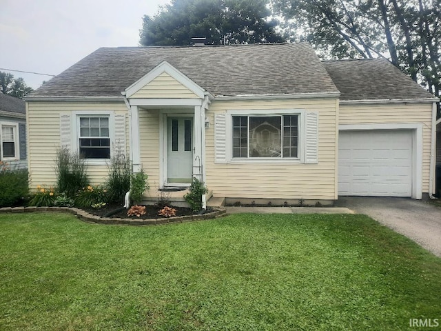 2629 S Meeker Ave, Muncie, IN 47302 - view of front of house with a garage, a front yard, driveway, and a shingled roof