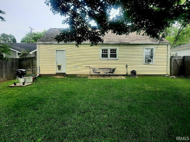 2629 S Meeker Ave, Muncie, IN 47302 - rear view of house with a fenced backyard and a shingled roof