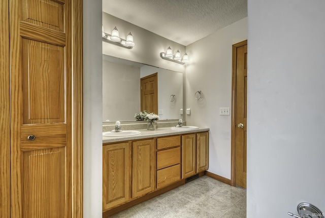 8005 Mackinac Cv, Fort Wayne, IN 46835 - bathroom featuring double vanity, a textured ceiling, and tile patterned floors