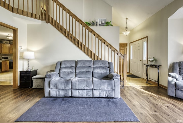 8005 Mackinac Cv, Fort Wayne, IN 46835 - living area with high vaulted ceiling, light wood-type flooring, and stairway