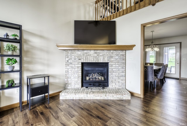 8005 Mackinac Cv, Fort Wayne, IN 46835 - living room with a chandelier, wood finished floors, and a fireplace
