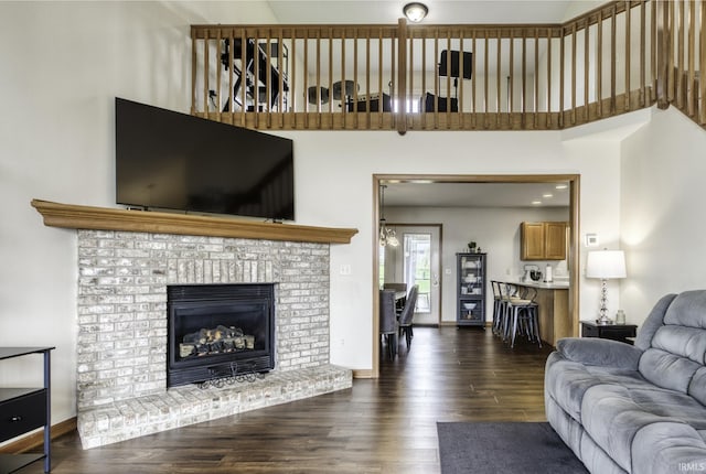 8005 Mackinac Cv, Fort Wayne, IN 46835 - living room featuring a towering ceiling, wood finished floors, and a fireplace