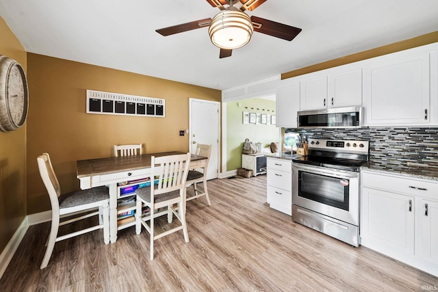 3822 Eastmont Dr, South Bend, IN 46628 - kitchen featuring appliances with stainless steel finishes, a ceiling fan, light wood-style flooring, and white cabinets