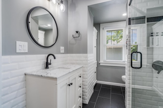 1209 S Jackson St, Auburn, IN 46706 - full bathroom with tile walls, vanity, a stall shower, tile patterned flooring, and wainscoting
