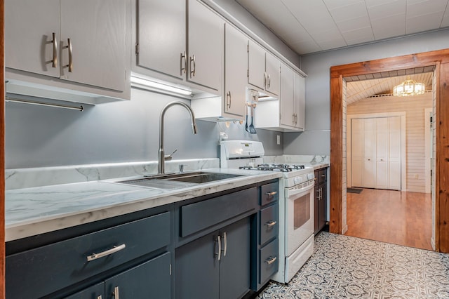 1209 S Jackson St, Auburn, IN 46706 - kitchen featuring white gas stove, light countertops, and white cabinets