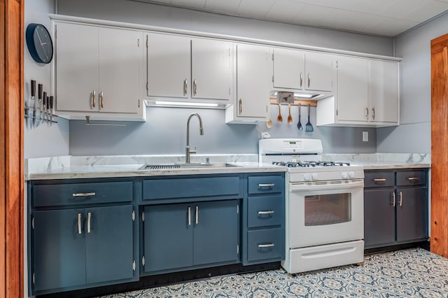 1209 S Jackson St, Auburn, IN 46706 - kitchen featuring gas range gas stove, light countertops, blue cabinets, and white cabinetry
