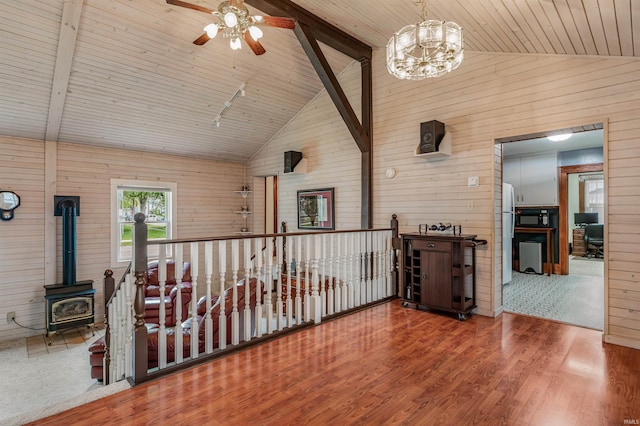 1209 S Jackson St, Auburn, IN 46706 - interior space featuring wooden walls, a ceiling fan, a wood stove, wood ceiling, and wood finished floors