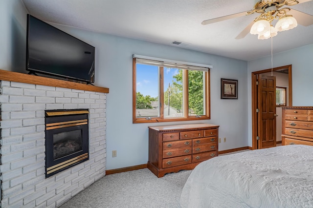 1209 S Jackson St, Auburn, IN 46706 - bedroom with light carpet, a brick fireplace, and ceiling fan