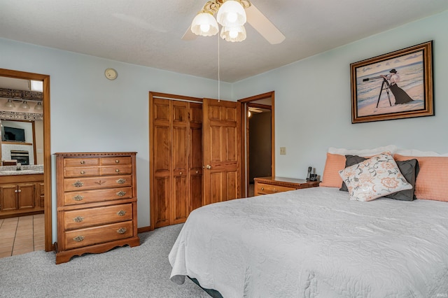 1209 S Jackson St, Auburn, IN 46706 - bedroom featuring a closet, light carpet, ceiling fan, and a fireplace