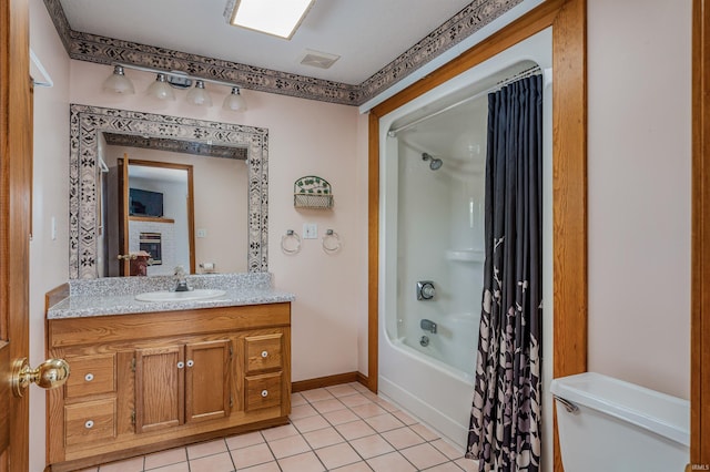 1209 S Jackson St, Auburn, IN 46706 - full bathroom featuring vanity, tile patterned flooring, shower / tub combo, and a brick fireplace