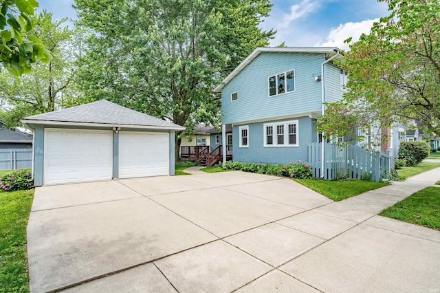 1209 S Jackson St, Auburn, IN 46706 - view of front of home featuring a garage, an outbuilding, and stucco siding