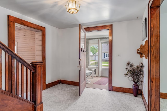 1209 S Jackson St, Auburn, IN 46706 - foyer entrance with carpet flooring, stairway, and a chandelier