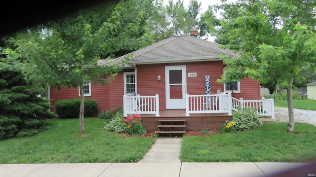 142 W Howard St, Galveston, IN 46932 - bungalow-style house with a chimney, a front lawn, and a shingled roof