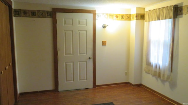 142 W Howard St, Galveston, IN 46932 - unfurnished bedroom with wood finished floors and a closet