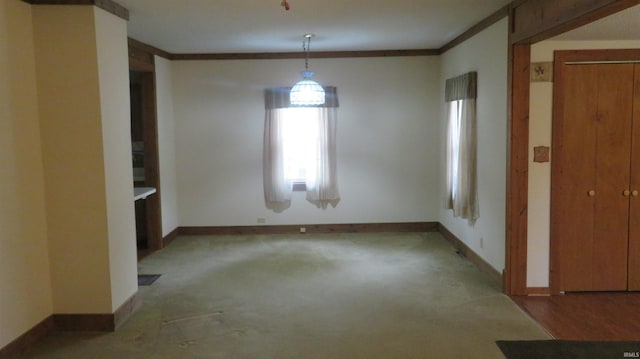 142 W Howard St, Galveston, IN 46932 - unfurnished dining area with baseboards and ornamental molding