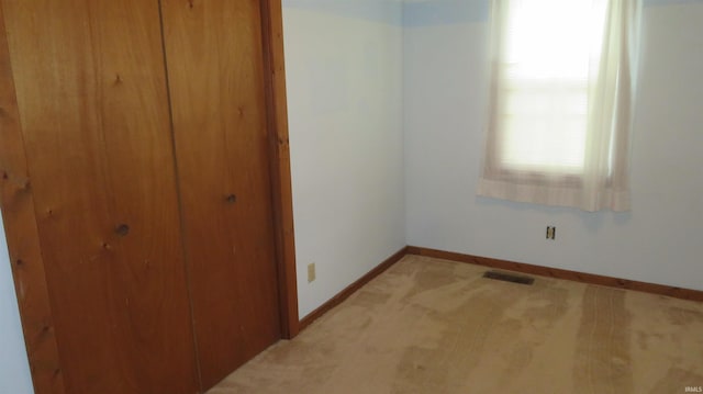 142 W Howard St, Galveston, IN 46932 - unfurnished bedroom featuring a closet and light carpet