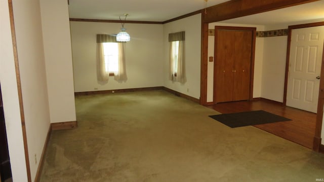 142 W Howard St, Galveston, IN 46932 - carpeted spare room with baseboards and crown molding